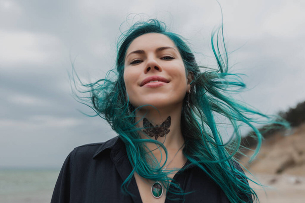 portrait of a beautiful woman with blue hair that flutters in the wind - Foto, afbeelding
