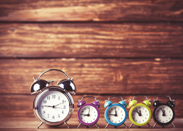 Retro alarm clocks on a table. Photo in retro color image style - Photo, Image