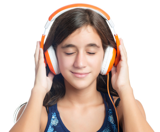 Beautiful hispanic teenage girl enjoying music on bright orange headphones - Zdjęcie, obraz