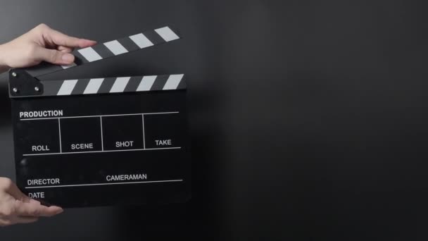 Movie clapperboard footage. Man hand holding film slate and clapping it in studio before shooting or recording. Movie clapper board or film slate for video recording. film production. film industry. - Footage, Video