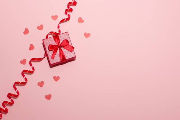 red ring box on pink background with hearts and ribbon - Fotoğraf, Görsel