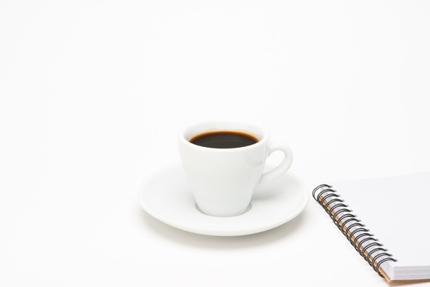 Cup of coffee with notebook - Foto, afbeelding