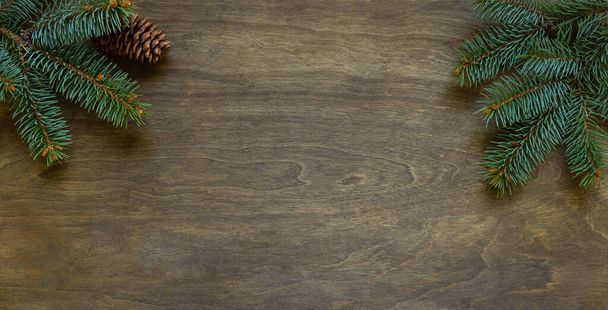 Christmas fir branch and cone on a wooden background. - Foto, Imagem
