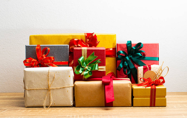 Gift boxes presents with ribbon on the table, white background. front view with copy space. - 写真・画像