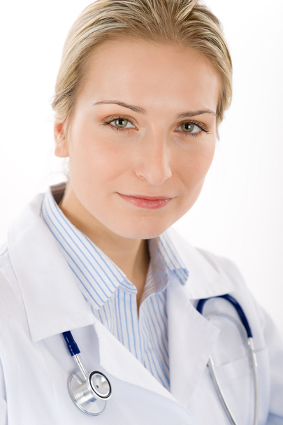 Young female doctor with stethoscope on white - Foto, afbeelding