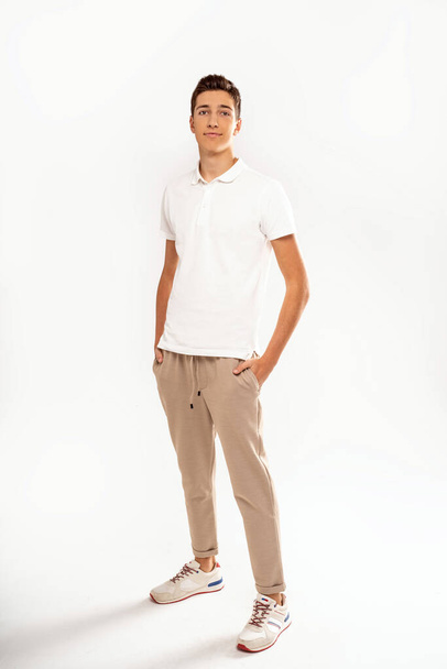 Full length photo of young handsome teenager man looking at the camera with smile, isolated on white backgroun - Foto, afbeelding