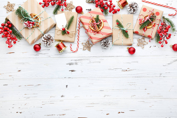 Gift boxes with ornaments on white wooden background - Foto, Imagem