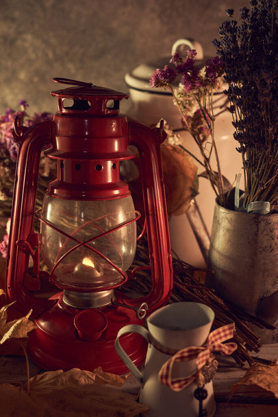 Vintage still life with an old kerosene lamp on a rustic background - Foto, afbeelding