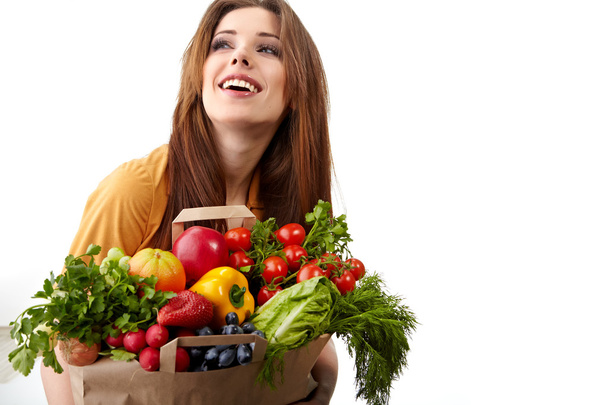 Woman holding a bag full of healthy food. shopping . - Foto, Imagen
