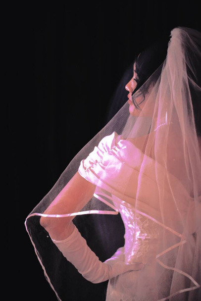 a girl in a black dress with a veil on her face - Photo, Image