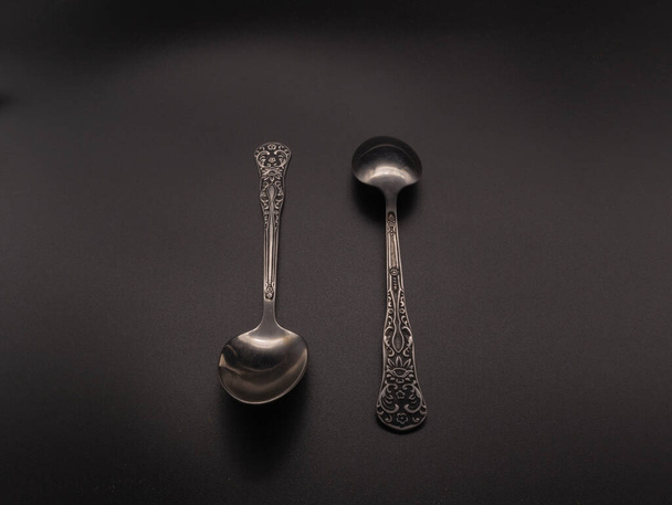 Two teaspoons on a dark background. Subject shooting - Φωτογραφία, εικόνα
