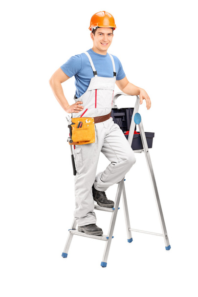 Male electrician standing on ladder - Fotó, kép