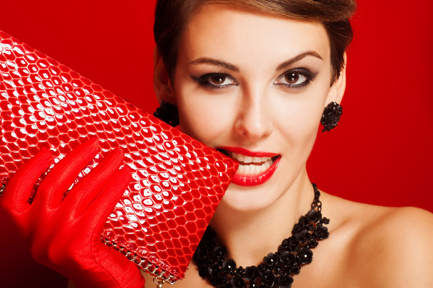 Beautiful girl with a red clutch bag - Photo, image
