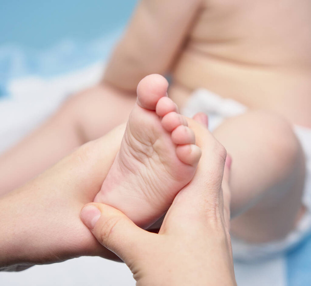 close-up massage of a baby on the limb - Фото, изображение