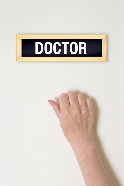 Female hand is knocking on Doctor door - Photo, image