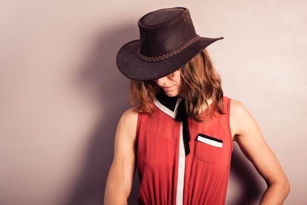 Young woman wearing red dress and cowboy hat - Valokuva, kuva