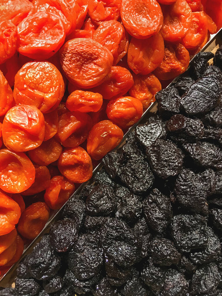 Boxes of dried apricots and prunes. Top view on dried fruits - tasty and healthy snack. - Φωτογραφία, εικόνα