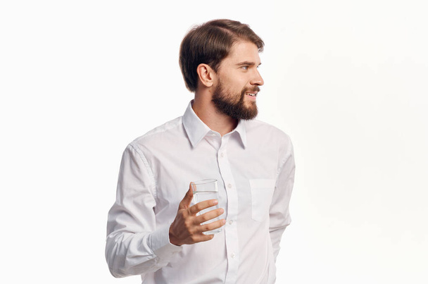 man in white shirt drinking water Studio - Foto, imagen