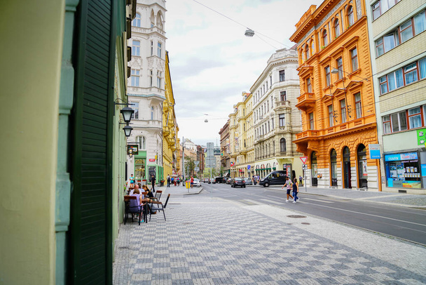Prague Czech Republic - September 1 2017; Long street through city with people crossing and enjoying cafe outdoors in typically European scene. - Valokuva, kuva