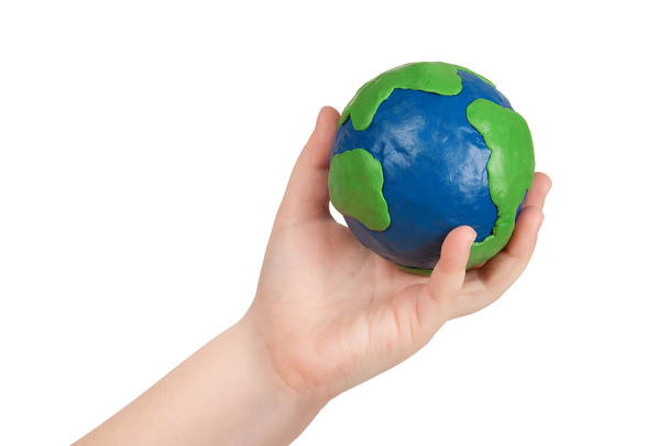 Child's hand holding a globe - Foto, Imagen