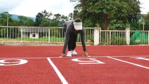 Athletic woman in sport clothes running on stadium track. Female runner jogging for exercise. Workout Healthy lifestyle concept. - Footage, Video