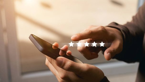 A male customer gives a five-star rating on their smartphone, satisfaction, customer service experience. Service Rating Reviews and Satisfaction Survey Concept. - Foto, Imagem