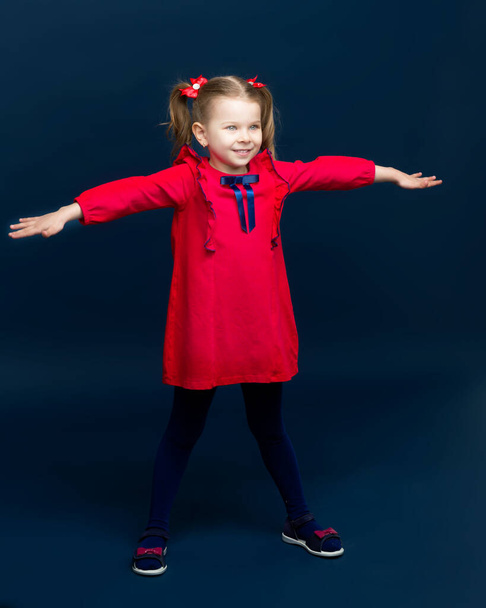 Cute little girl stand with her arms outstretched - Foto, Bild