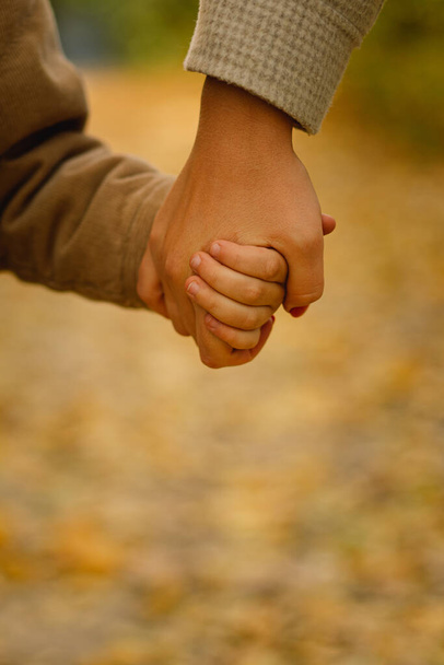 Mom and son hold hands. Happy family and support. Family day. - Photo, Image