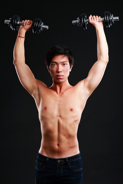 Handsome asian man isolated on black background - Foto, imagen