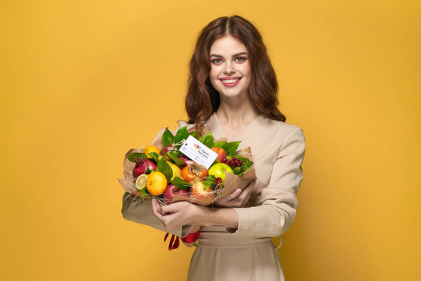 beautiful woman fun posing fruit bouquet vitamins colorful background - Photo, image
