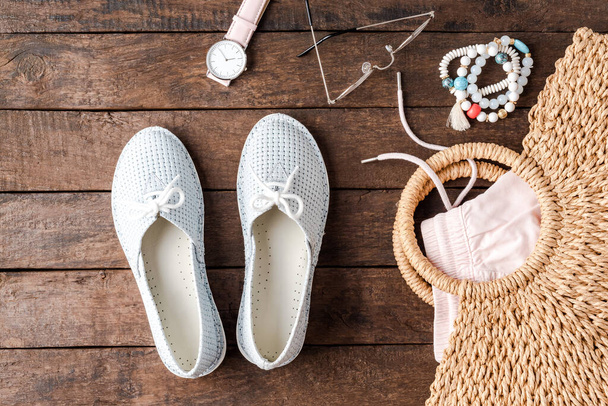 Summer outfit with blue shoes, straw bag and accessories - 写真・画像