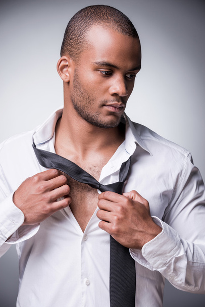 Black man taking off his necktie - Foto, imagen