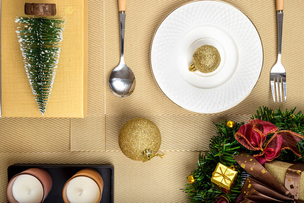 Top kilátás a karácsonyi asztal beállításait arany színű baubles.  - Fotó, kép