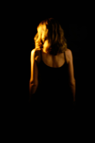 color art portrait of femininity, unfocused image of a female silhouette in dark tones. fashionable style of photography. place for text - Photo, image