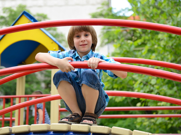 Boy playing on playground - Foto, Bild