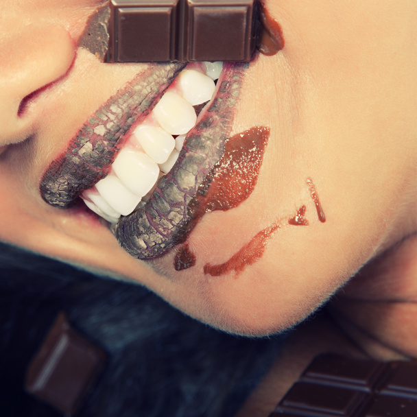 Young woman eating chocolate - Fotó, kép