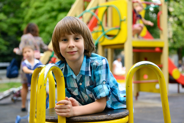 Boy playing on playground - Foto, Bild
