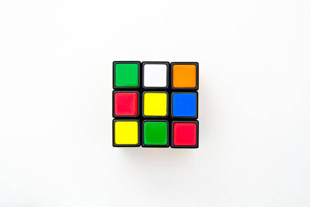 Saint-Petersburg, Russia - JULY 17, 2019 : Rubik's cube, rubik's cube top view isolated, rubik's cube on white background, colorful puzzle, math problem, charging for your brain, cube rainbow palette - Photo, image