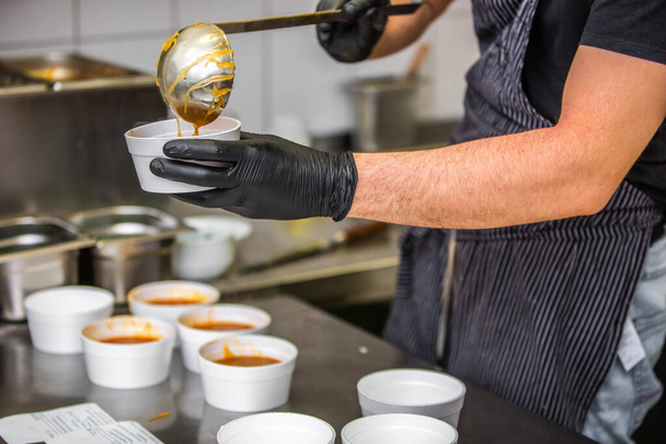 Chef preparing takeaway dish in the restaurant or pub , food delivery concept, home delivery, online order - 写真・画像