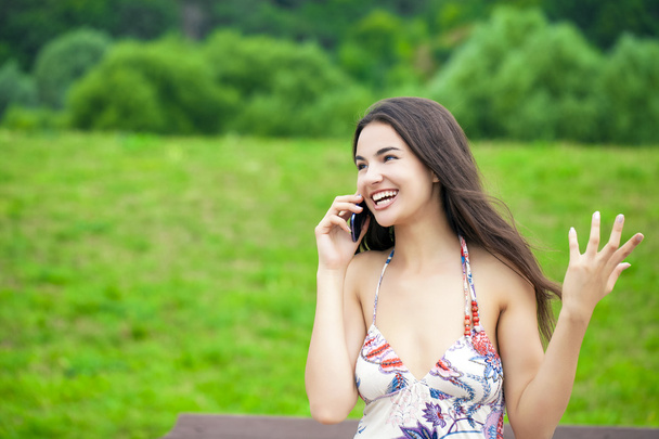 Happy beautiful girl calling by phone  - Foto, Imagen