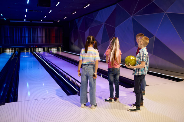 Group of children on the lane in bowling alley - Photo, Image