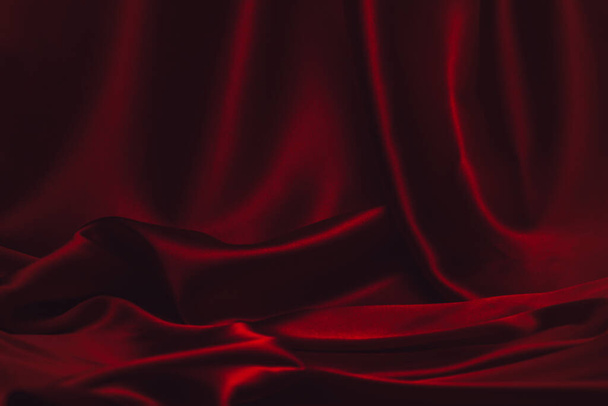 Red silk or satin luxury fabric texture can use as abstract background. Top view - Foto, Imagem