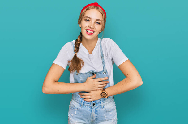 Young caucasian girl wearing casual clothes smiling and laughing hard out loud because funny crazy joke with hands on body.  - Fotoğraf, Görsel