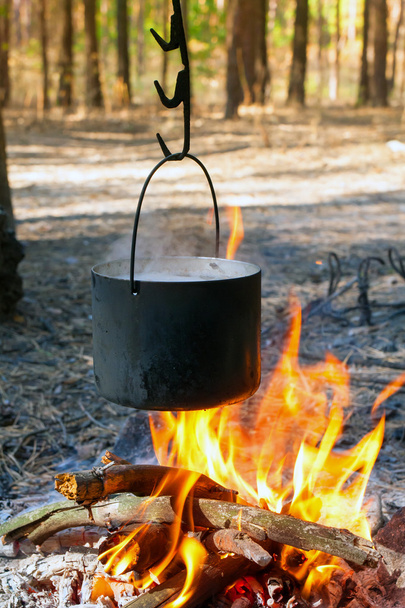 Tourist kettle over camp fire - Fotó, kép