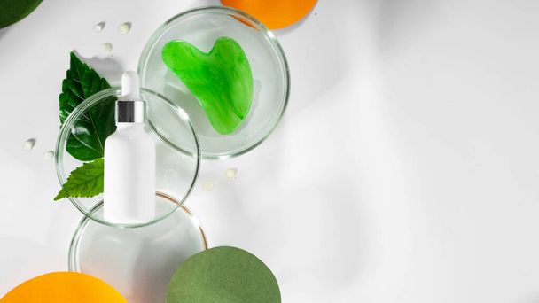 Polyglutamic acid, for deep hydration and facial skin care. Petri dishes with green leaf and water. Background with colored orange paper and shadows. Concept New beauty Anti age trend. Copy spase - Fotografie, Obrázek