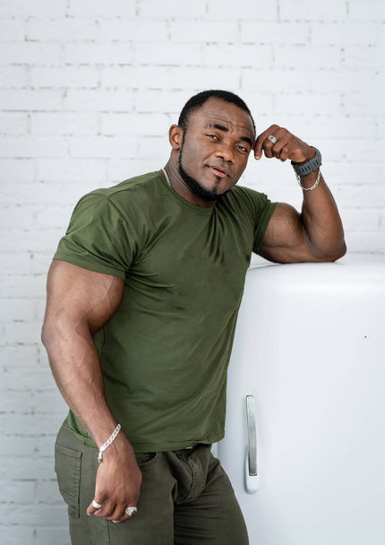 Strong muscular bodybuilder in studio looking to camera. Sporty athletic strong macho in studio. - 写真・画像