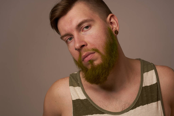 national bearded man in a striped jersey hipster tattoos on his arms - 写真・画像