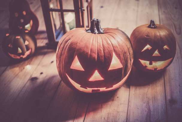spooky Jack O' Lanterns on wooden table Glowing In Fantasy Night. Halloween Background - Фото, зображення