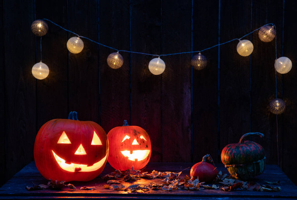 Halloween - Jack O 'Lanterns - Candles And String Lights On Wooden Table
 - Фото, изображение