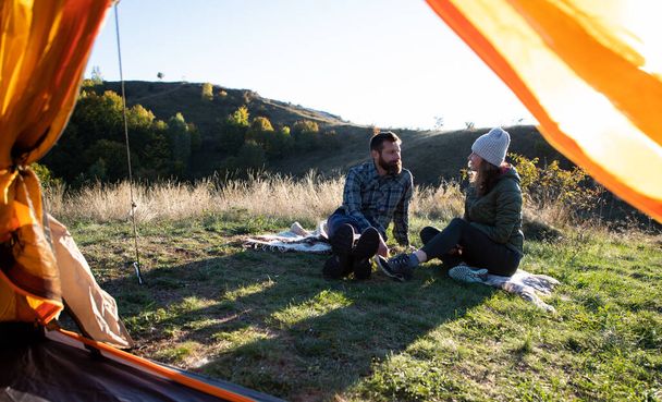 happy friends camping with dog in autumn landscape - Foto, immagini